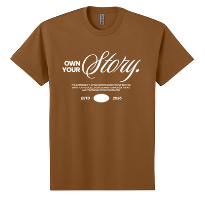 Omina brown heavyweight cotton oversized t-shirt with white "Own Your Story" graphic and "ESTD 2026" text.