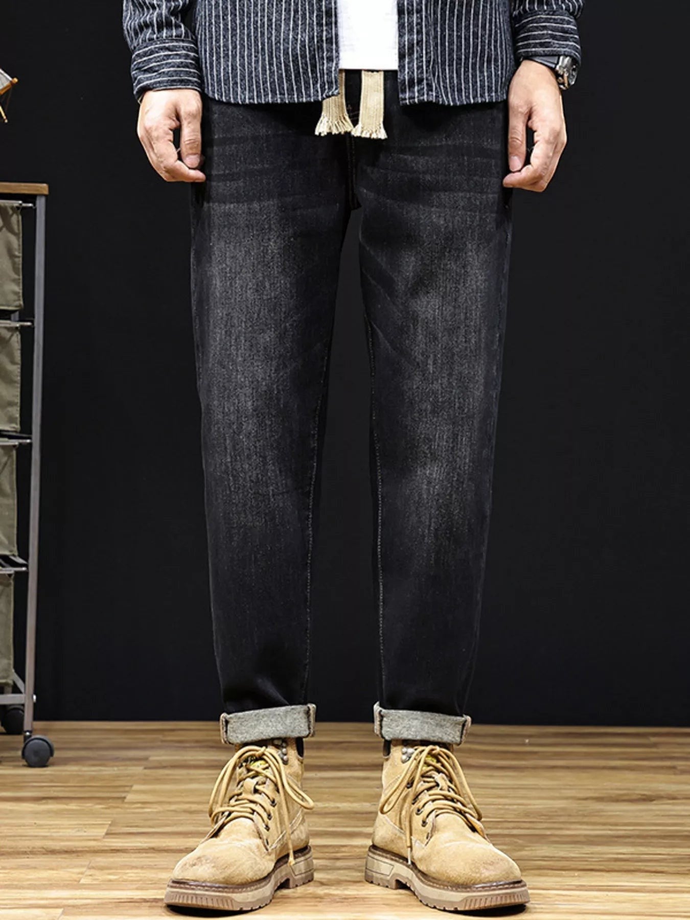 Omina relaxed fit dark wash denim trousers with drawstring waist and utility pockets, cuffed hem.