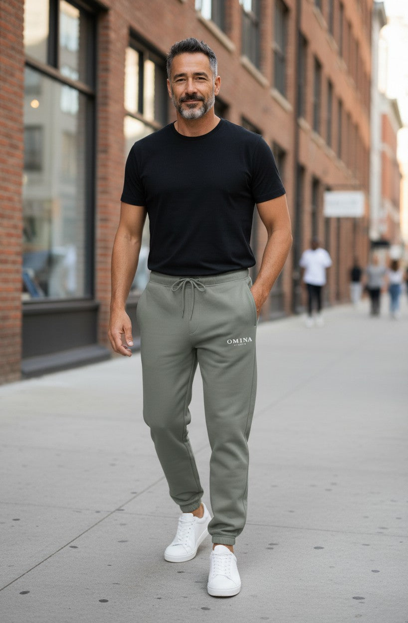 Omina Studio Relax Track Pants in sage green, featuring a drawstring waist and cuffed ankles. Made from soft, comfortable fabric.