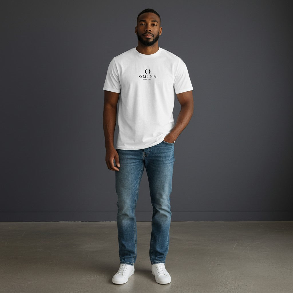 Model wearing a white Omina Essentials seamless cotton crew neck t-shirt with blue jeans and white sneakers.