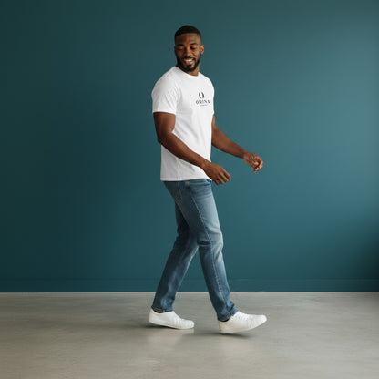 Man wearing a white Omina seamless cotton crew neck t-shirt with blue jeans against a dark teal background.