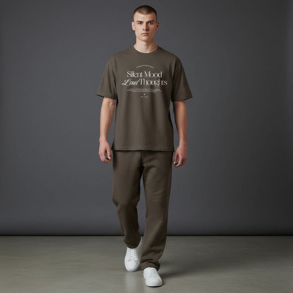 Omina Silent Mood unisex jersey tee in olive green cotton with white graphic text worn by a male model.