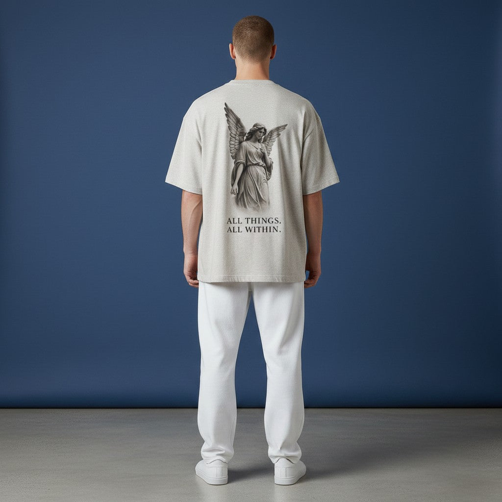 OMINA Studio light grey heathered cotton t-shirt with angel graphic and text "ALL THINGS, ALL WITHIN."