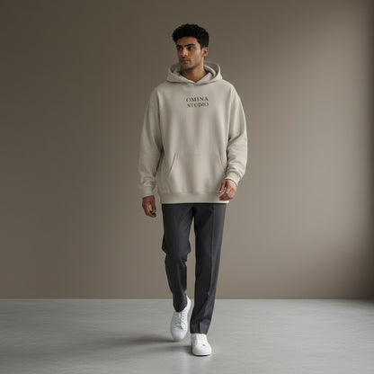 Omina Studio beige heavyweight cotton hoodie with relaxed oversized fit and front pocket.