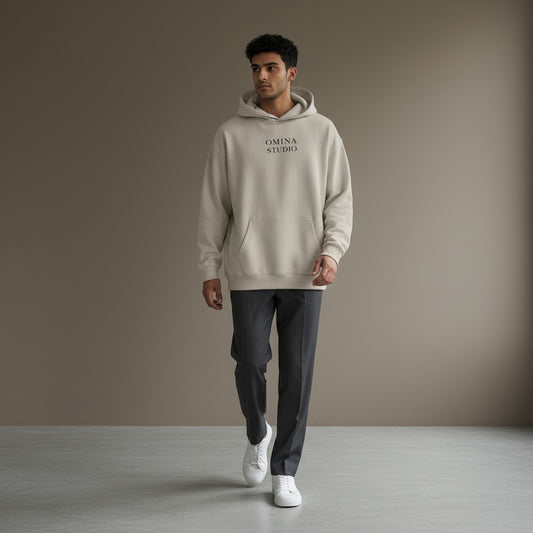 Omina Studio beige heavyweight cotton hoodie with relaxed oversized fit and front pocket.