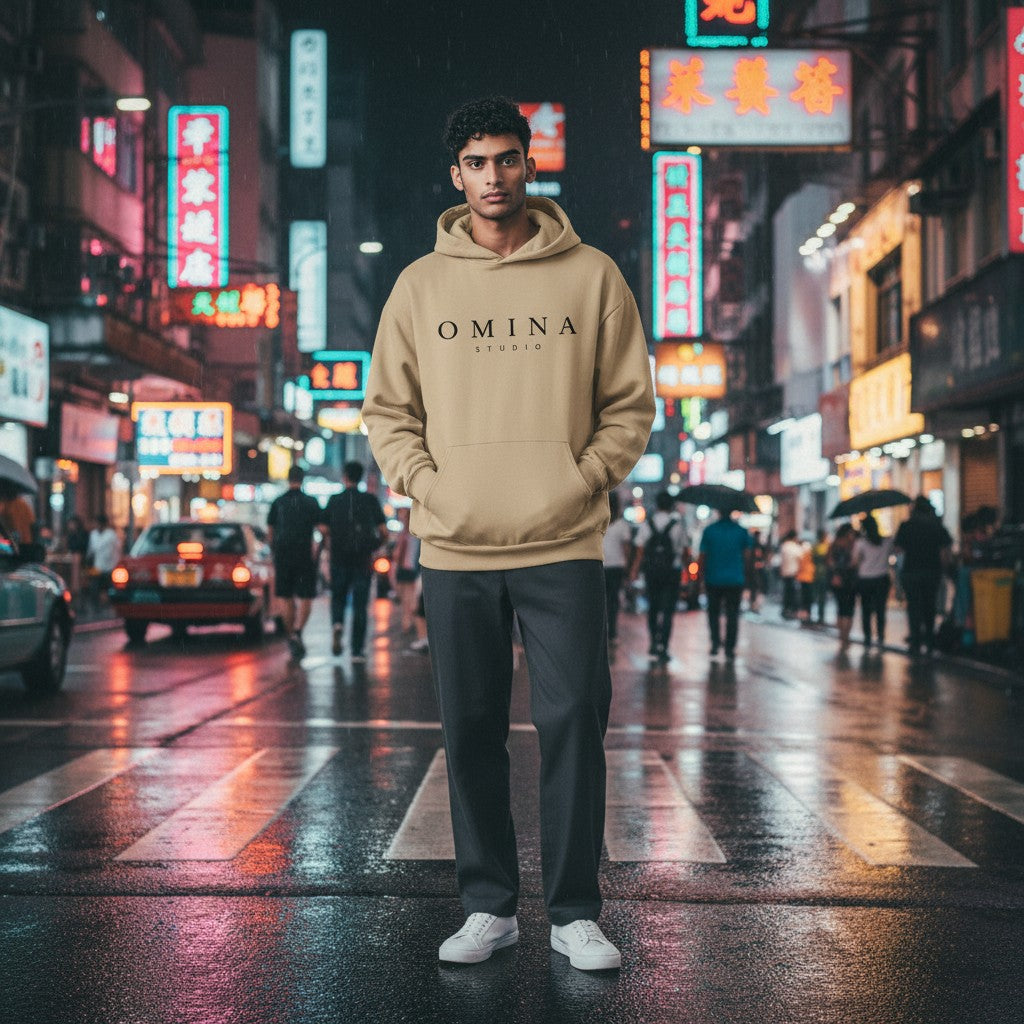 Omina Studio beige hooded sweatshirt with kangaroo pocket and black logo on chest. Made from midweight cotton-poly blend.