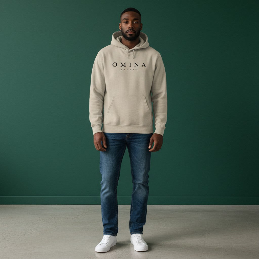Omina Studio beige pigment-dyed cotton blend hoodie with front logo and relaxed fit.