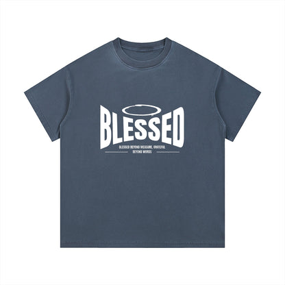 Omina Studio vintage wash cotton t-shirt with white "Blessed" graphic and halo detail.