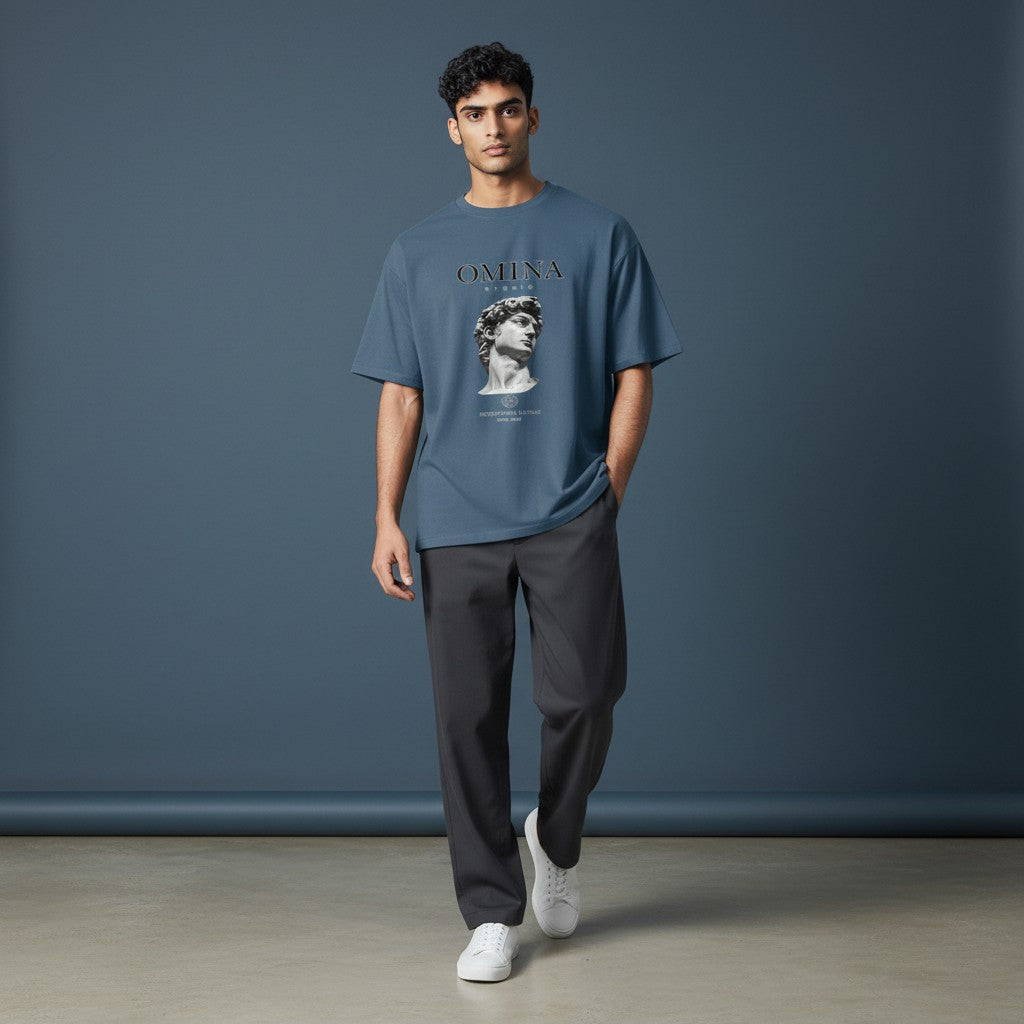 OMINA Studio blue heavyweight cotton t-shirt with Michelangelo's David graphic and "Intentional Living" text.