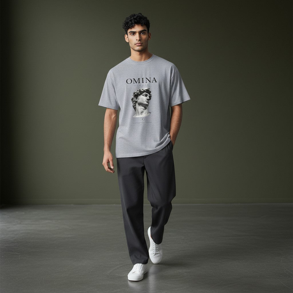 OMINA Studio grey heavyweight cotton t-shirt with a relaxed fit, featuring a graphic of Michelangelo's David bust and "Intentional Living" text.
