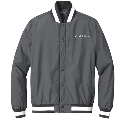 OMINA Studio grey insulated varsity jacket with white striped collar and cuffs, snap-button front, and logo.