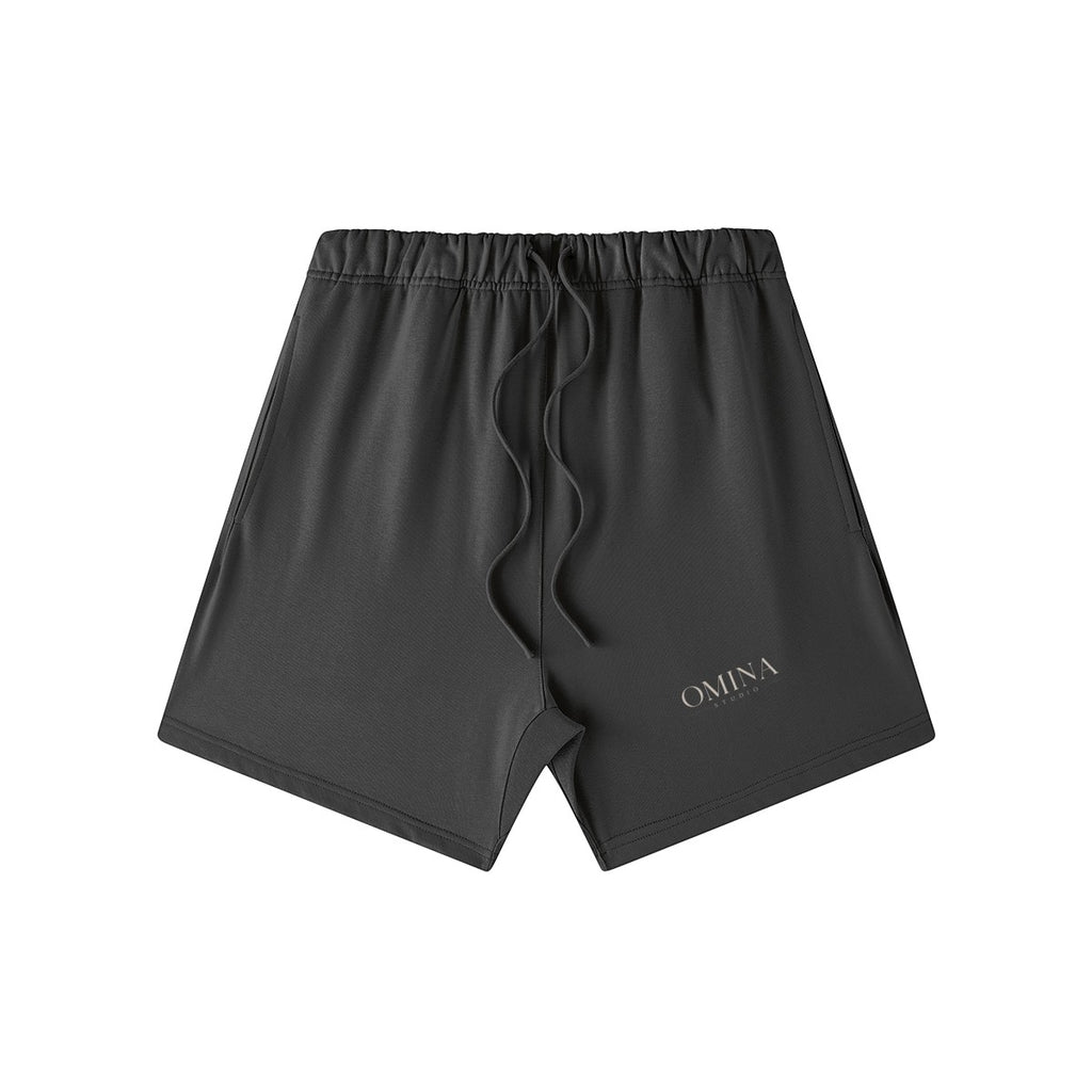 Omina Studio charcoal grey heavyweight French terry shorts with elastic waist, drawstring, and side pockets. Oversized fit.