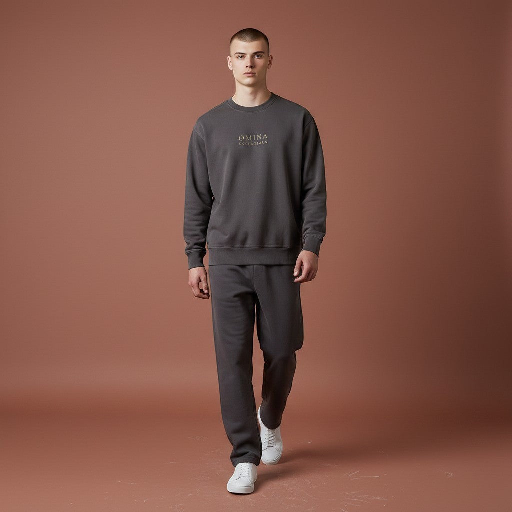 OMINA Studio charcoal grey heavyweight cotton sweatshirt with crew neck and subtle gold logo detail.