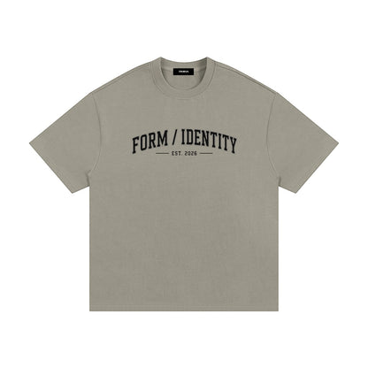 OMINA Studio heavyweight cotton t-shirt in taupe with "FORM / IDENTITY EST. 2026" graphic on front.