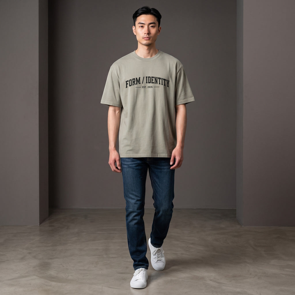 Omina Studio heavyweight cotton t-shirt in taupe with 'FORM / IDENTITY EST. 2026' graphic on front.