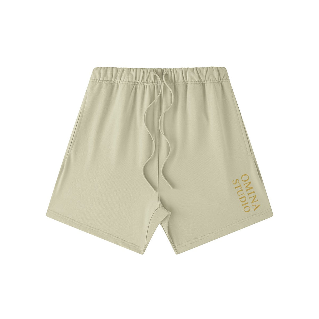 Omina Studio heavyweight beige French terry cotton shorts with drawstring and side pockets.
