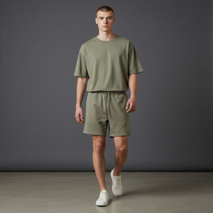 Omina Studio olive green heavyweight cotton French terry shorts with drawstring and side pockets.