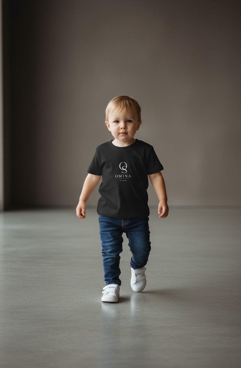 Omina Studio black infant t-shirt made from soft, breathable fine jersey cotton with a classic fit and minimalist logo.