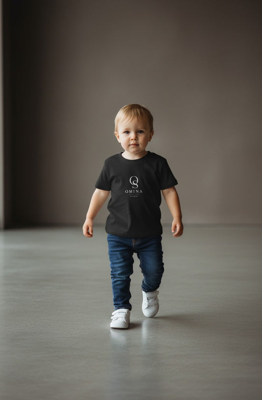 Omina Studio black infant t-shirt made from soft, breathable fine jersey cotton with a classic fit and minimalist logo.