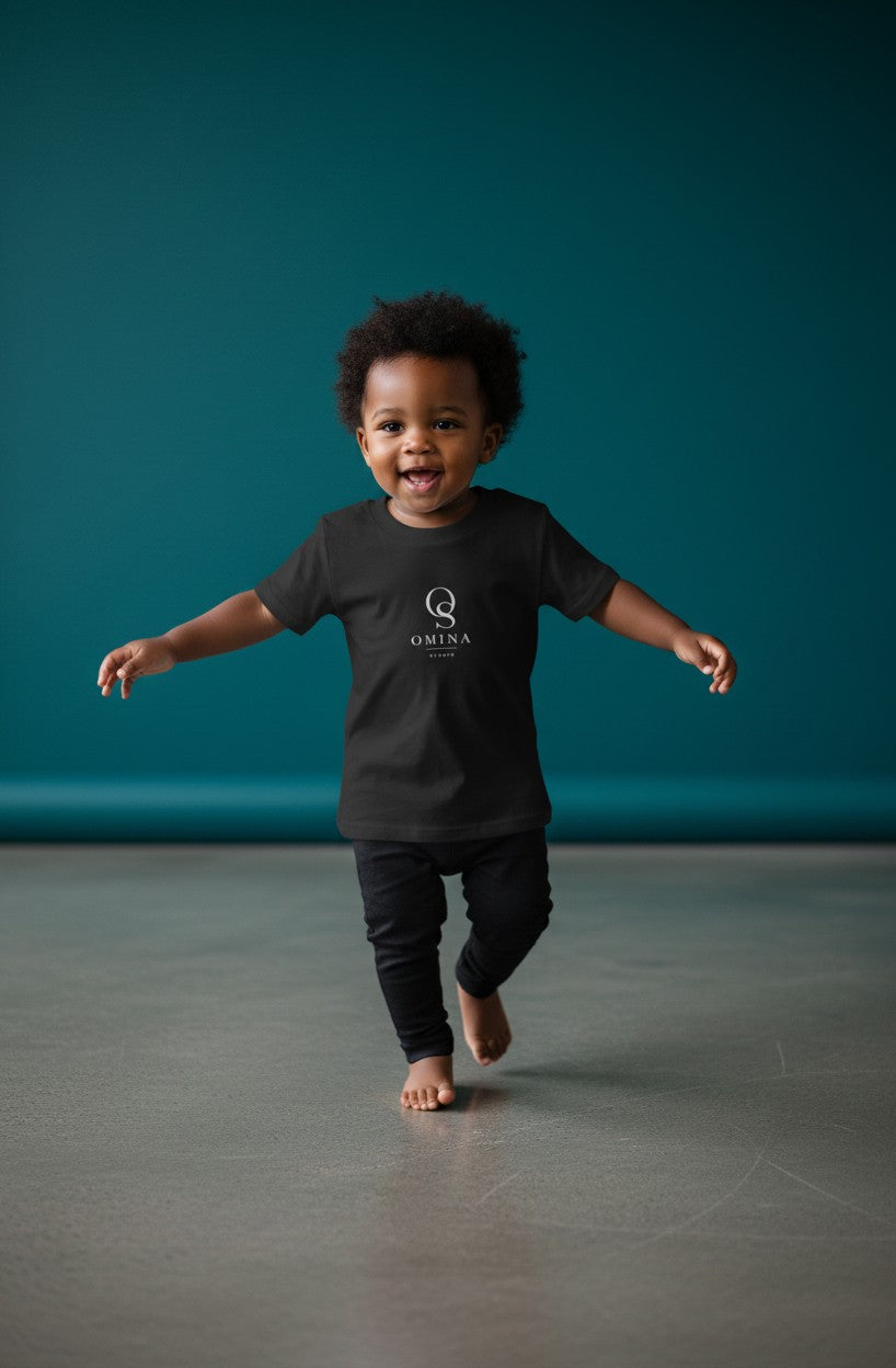 Omina Studio black infant t-shirt made from soft, breathable cotton with a classic fit and minimalist logo.