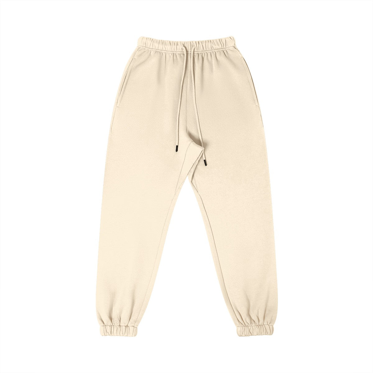 Omina Studio cream 100% combed cotton minimalist sweatpants with tapered fit, elastic waistband, drawstring, and cuffed ankles.