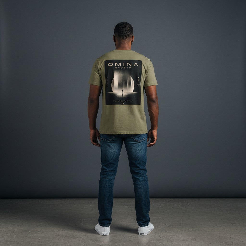 Omina Studio olive green heavyweight cotton t-shirt with a graphic of a person standing in front of a large moon-like circle with abstract vertical elements and text.