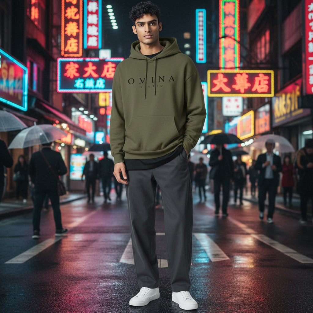 Omina Studio olive green hooded sweatshirt with kangaroo pocket and black logo.