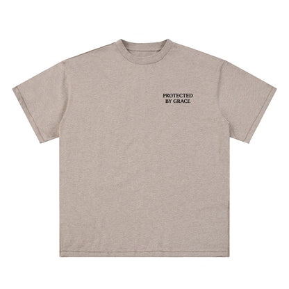 OMINA Studio beige essential cotton t-shirt with "PROTECTED BY GRACE" text on the chest.