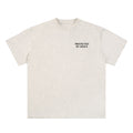 OMINA Studio light grey heathered cotton t-shirt with "PROTECTED BY GRACE" text on the left chest.