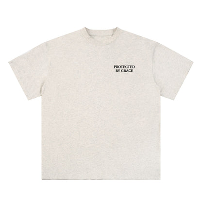 OMINA Studio light grey heathered cotton t-shirt with "PROTECTED BY GRACE" text on the left chest.