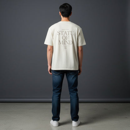 Omina Studio cream cotton blend t-shirt with "STATE OF MIND" graphic print on back. Short sleeve, crew neck.