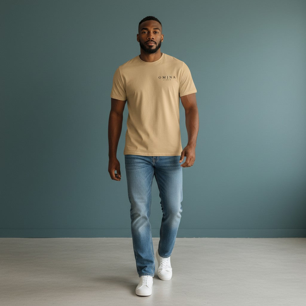 Omina Studio tan heavyweight cotton t-shirt with a small black logo on the left chest. Relaxed fit.