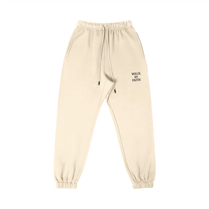 Omina Studio Walk By Faith cream heavyweight cotton sweatpants with tapered fit and drawstring.