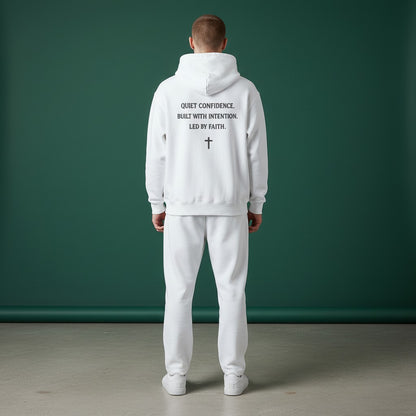 Omina Studio white heavyweight cotton pullover hoodie with "Quiet Confidence. Built With Intention. Led By Faith." graphic and a cross.