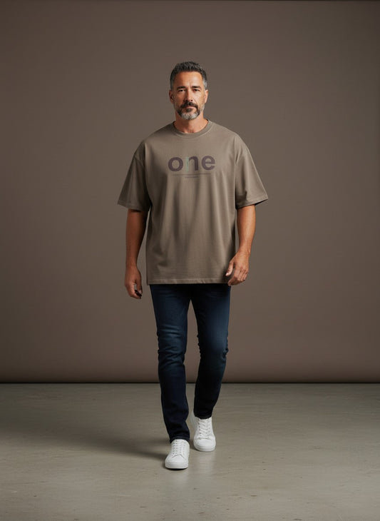 Omina men's oversized short sleeve t-shirt in taupe with a large 'one' graphic and text detail. Made of cotton and spandex.