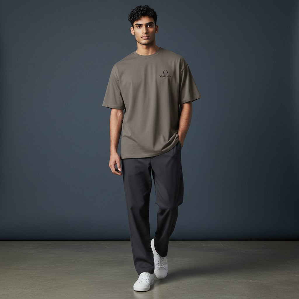 Model wearing an Omina heavyweight taupe cotton t-shirt with a relaxed fit and small chest logo
