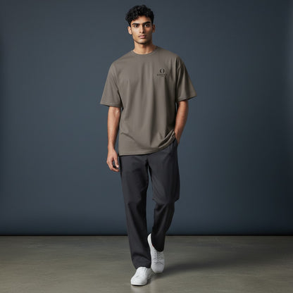 Model wearing an Omina heavyweight taupe cotton t-shirt with a relaxed fit and small chest logo