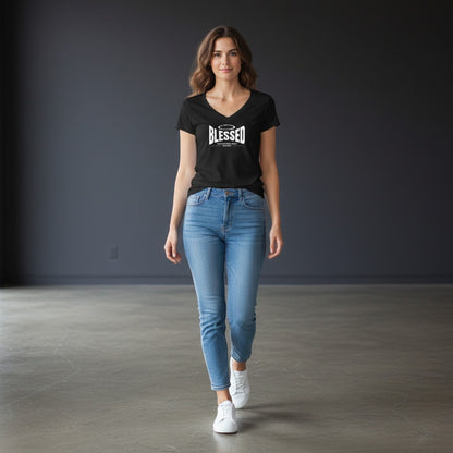 A woman wearing an Omina black Tencel slim fit V-neck T-shirt with a white graphic, paired with blue jeans and sneakers.
