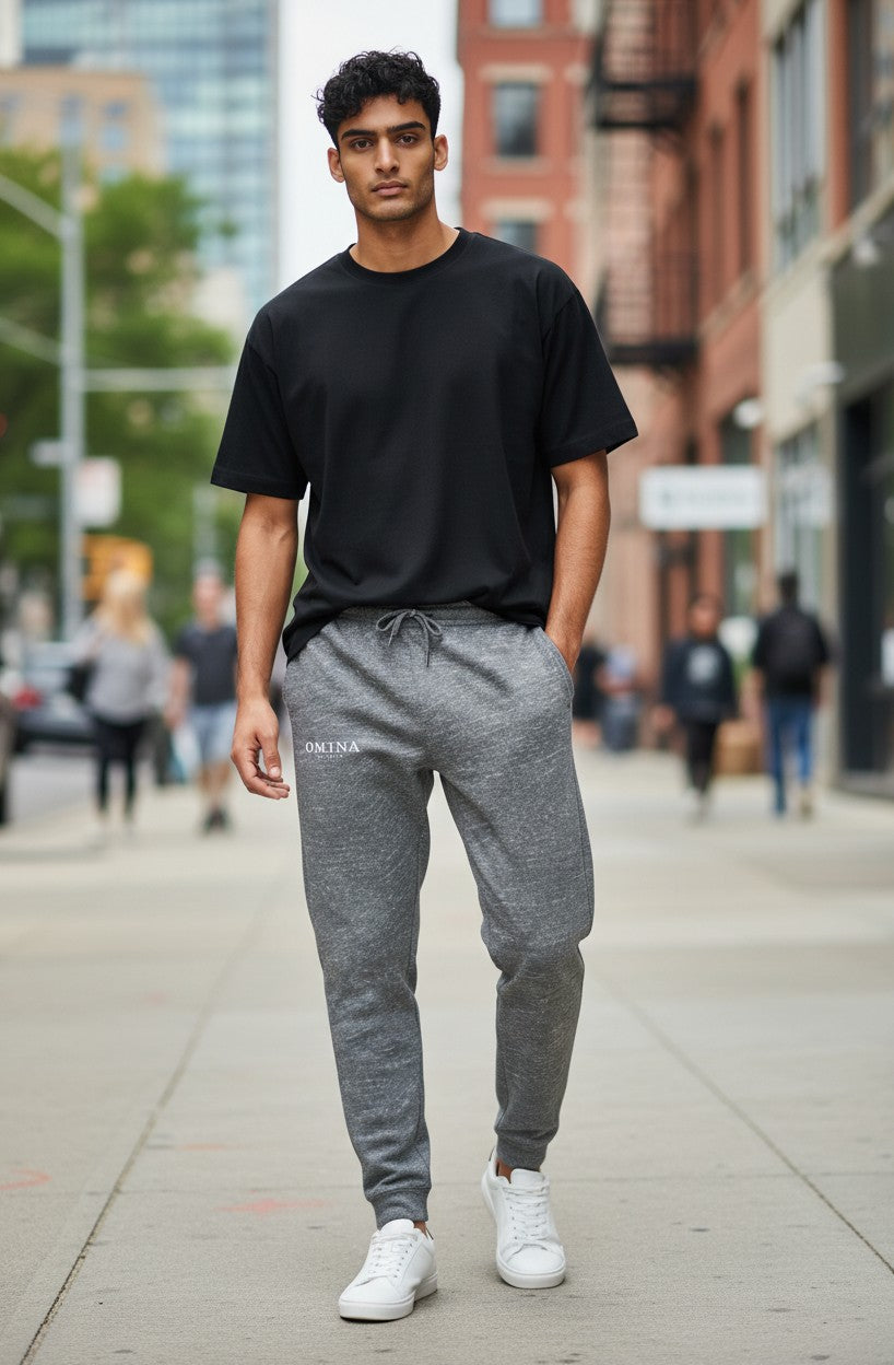 Omina Studio unisex premium joggers in heather grey marl cotton blend. Relaxed fit with drawstring waist and cuffed ankles.