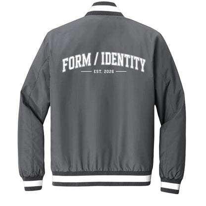 Omina grey insulated varsity jacket with white "FORM / IDENTITY EST. 2026" graphic on back and striped rib-knit collar, cuffs, and hem.