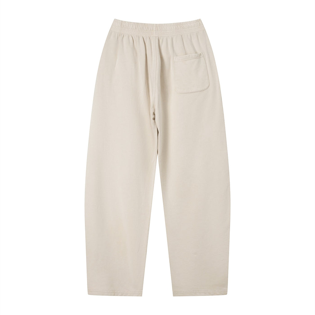 Omina Studio unisex vintage wash loose sweatpants in light beige, made from a soft heavyweight cotton blend with a single back pocket.