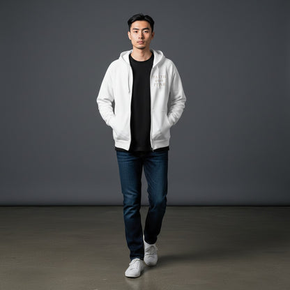 Model wearing an Omina white heavyweight cotton zip hoodie with Faith Over Fear text over a black shirt and jeans