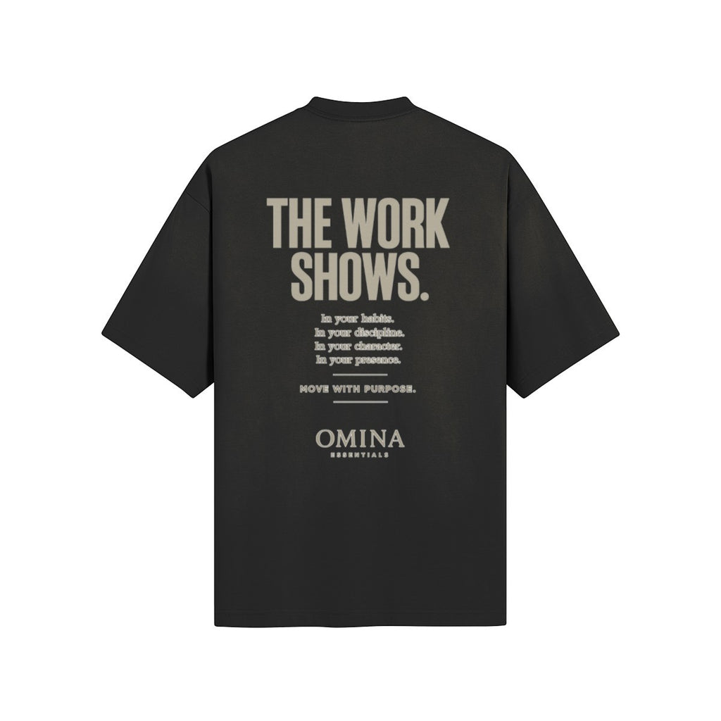 Omina black cotton t-shirt with "THE WORK SHOWS." graphic text and minimalist logo.