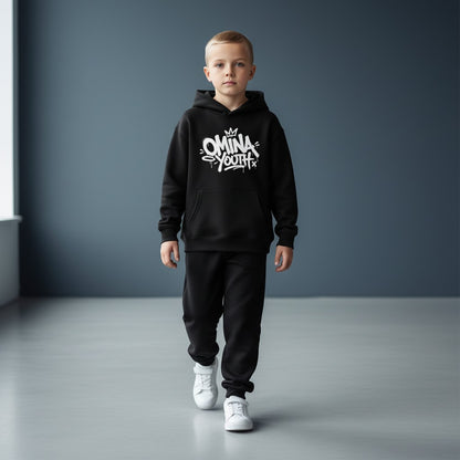 Young boy wearing an Omina black fleece pullover hoodie with white graffiti-style chest graphic and matching joggers.