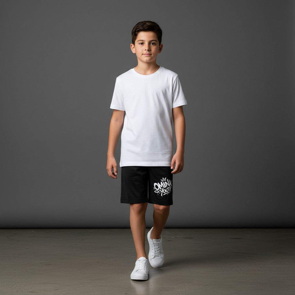 Omina Youth black relaxed fit shorts with white graffiti-style logo on the left leg. Elastic waistband.
