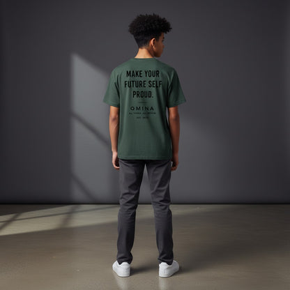 A youth wearing an Omina green performance t-shirt with Future Self Proud text on the back, standing in a studio.